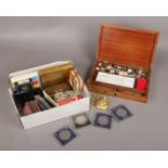 A box of collectables, to include commemorative coins, student's paint box, playing cards etc.