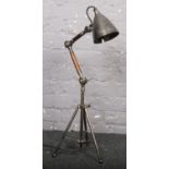 An adjustable wood & metal angle poise table lamp