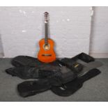 An Elevation acoustic guitar in carry case, along with six guitar carry cases.