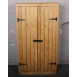 A vintage pine metal bound cupboard. 91cm wide x 163cm tall.