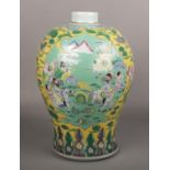 A Chinese 20th century yellow ground baluster vase. Painted in famille verte enamels with a group of