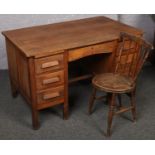 A oak knee hole desk along with a spindle back chair. 67cm depth x 127cm wide x 79cm tall. some