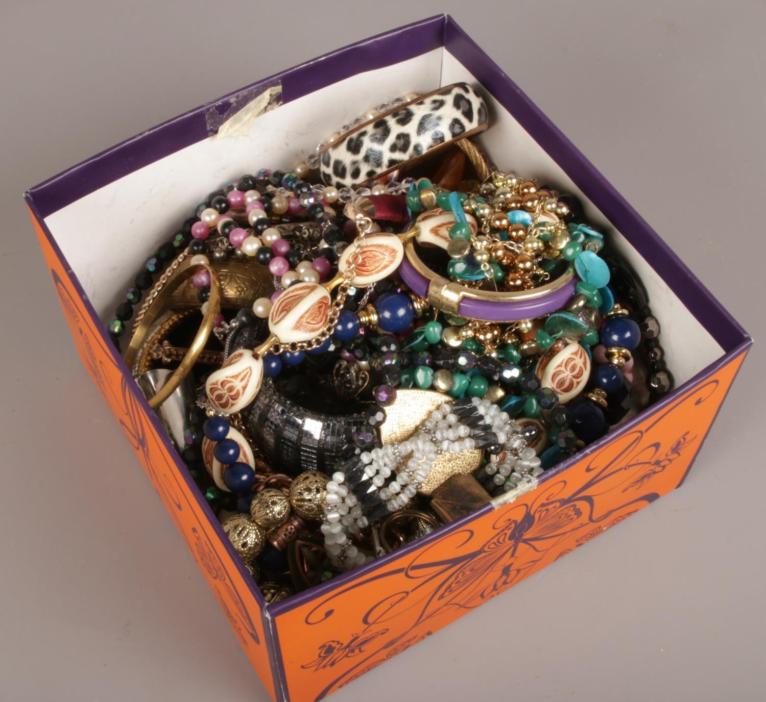 A box of costume jewellery to include beads, bangles, necklaces etc.