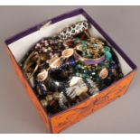 A box of costume jewellery to include beads, bangles, necklaces etc.