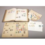 Two albums and a collection of loose world stamps.