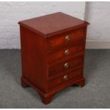 A yew wood four drawer chest banded in mahogany.