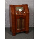 An Art Deco walnut cased valve radio. Marked R. A. P. Limited, 85cm.