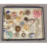 A tray of costume brooches to include white and coloured paste stones examples etc.