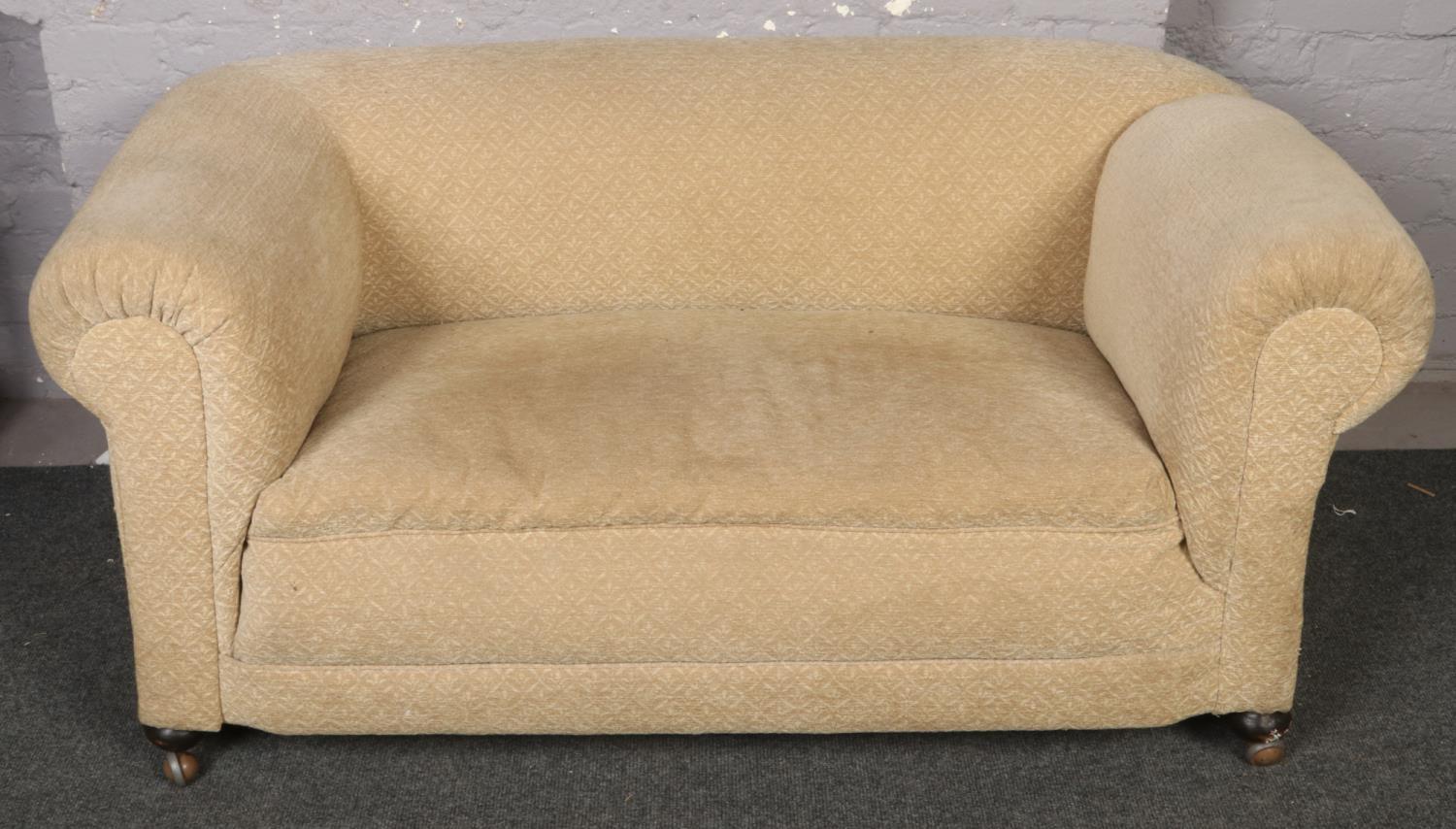 A 1920s drop arm two seat sofa.