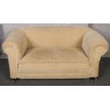 A 1920s drop arm two seat sofa.