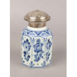 A Dutch delft blue and white jar with silver top