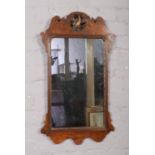 A mahogany framed wall mirror, with carved bird decoration.