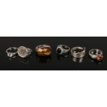 Six silver dress rings including Georgian spoon ring, tigers eye, and coin set examples.