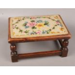 A wooden tapestry topped footstool (15 cm height 31 cm wide)