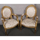 Two French style giltwood armchairs.