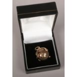 A silver gilt masonic orb ball and cross pendant