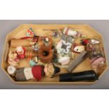 A tray of collectables including wooden nut cracker, bottle openers and other trinkets.