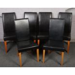 Four black leatherette dining chairs along with a pair of similar chairs.