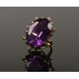 An 18ct gold amethyst and diamond cocktail ring. With a large faceted ovoid amethyst 25mm x 18mm,
