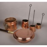 An antique copper planter with iron handles, three copper cider toddys and a copper bed warming pan.