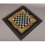 A vintage chess board, with gilt and foil decoration. (48cm x 48cm).