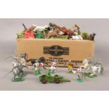 A box of vintage assorted plastic toy soldiers, horses and figures