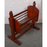 A carved mahogany babies rocking crib.