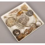 A white metal filigree pill box along with a small quantity of costume jewellery to include rings,