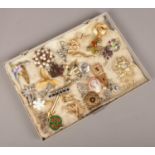 A tray of costume brooches to include colour and white paste stone examples etc.