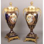 A large pair of C20th Sevres style mantel urns with gilt metal mounts. Ground in gros bleu, gilded