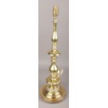 A large ornate brass table lamp.