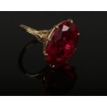 A vintage 9ct gold cocktail ring set with a large ovoid red stone. Assayed London 1968. Size N.