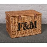 A Fortnum & Mason picnic basket with leather straps, 56cm wide.