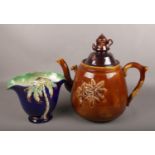 A large 19th century treacle glaze punch pot, along with a Beswick palm tree vase. Spout on lid of