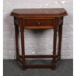 A small oak side table with single drawer.