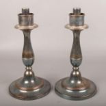 A pair of late 19th century silver plate candlesticks.