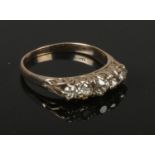 An 18ct gold five stone diamond ring. With scrolling shank set with five round cut diamonds,