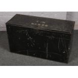 A black painted tin trunk, stencilled S&SYN No.3.