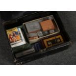 A tin box of collectables to include postcards, parker pens, printing blocks etc.
