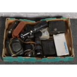 A box of cameras to include praktica, bellows, camera lenses, box camera etc.