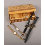 A wooden jewellery box to include quartz wristwatches, rings, bangle.