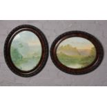 A pair of oval carved framed prints, landscape scene