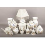 A collection of Aynsley Cottage Garden bone china, to include table lamp, lidded urns etc.