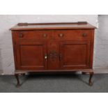 A Victorian carved mahogany sideboard, raised on cabriole supports.