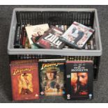 A box of Dvds, Indiana Jones complete movie collection, Twelve Monkeys, Young Guns examples