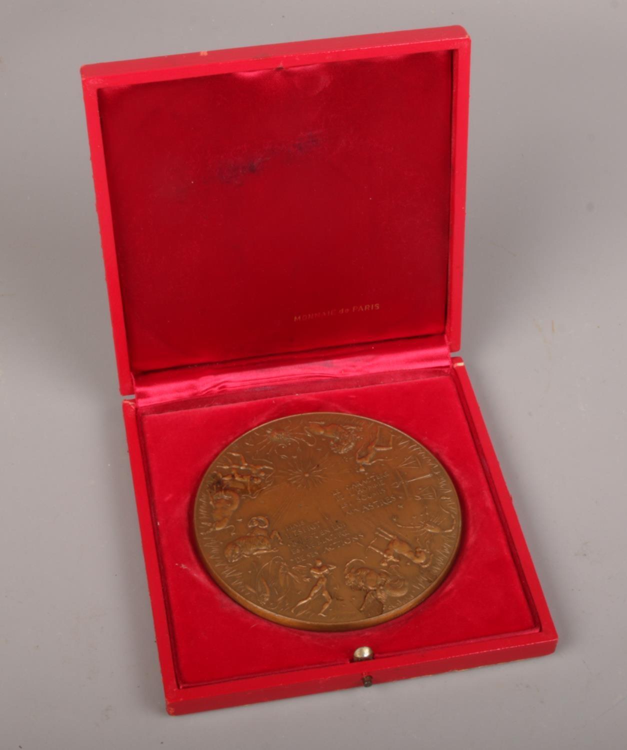 A Monnial de Paris Bronze Zodiac medallion in case