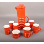 A 1970's Carltonware coffee set, with orange glaze and banded decoration. Good condition.