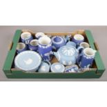 A box of blue Wedgwood jasperware to include teapots, jugs, cabinet plates, lighter etc.
