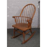 A mahogany spindle back rocking arm chair.