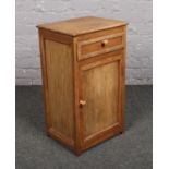An oak and pine bedside cupboard, with single drawer.